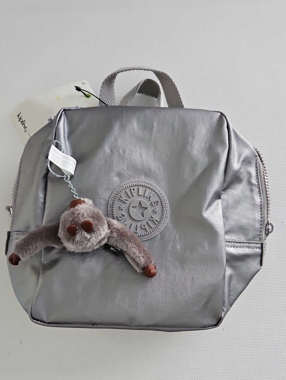 Kipling Metallic Silver Kids Backpack with Plush Monkey Charm
